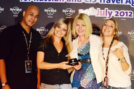 Ian Sutedjo (left) (director of sales and marketing for Hard Rock Hotel Pattaya) and Svetlana Katorgina (right - senior sales manager for Russia & C.I.S. for Hard Rock Hotel Pattaya) present a thank you award to Russian tours guides Lyria and Tatyana from Russian tour company Biblio Globus.